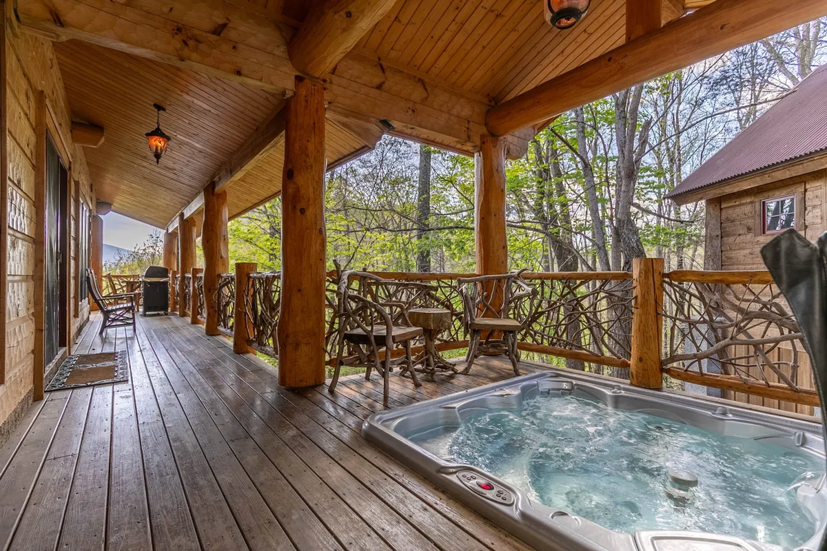 This image features a private hot tub nestled on a rustic deck surrounded by natural scenery, with wooden posts and comfortable outdoor furniture. The tranquil setting evokes a sense of relaxation and luxury, ideal for unwinding after outdoor adventures.